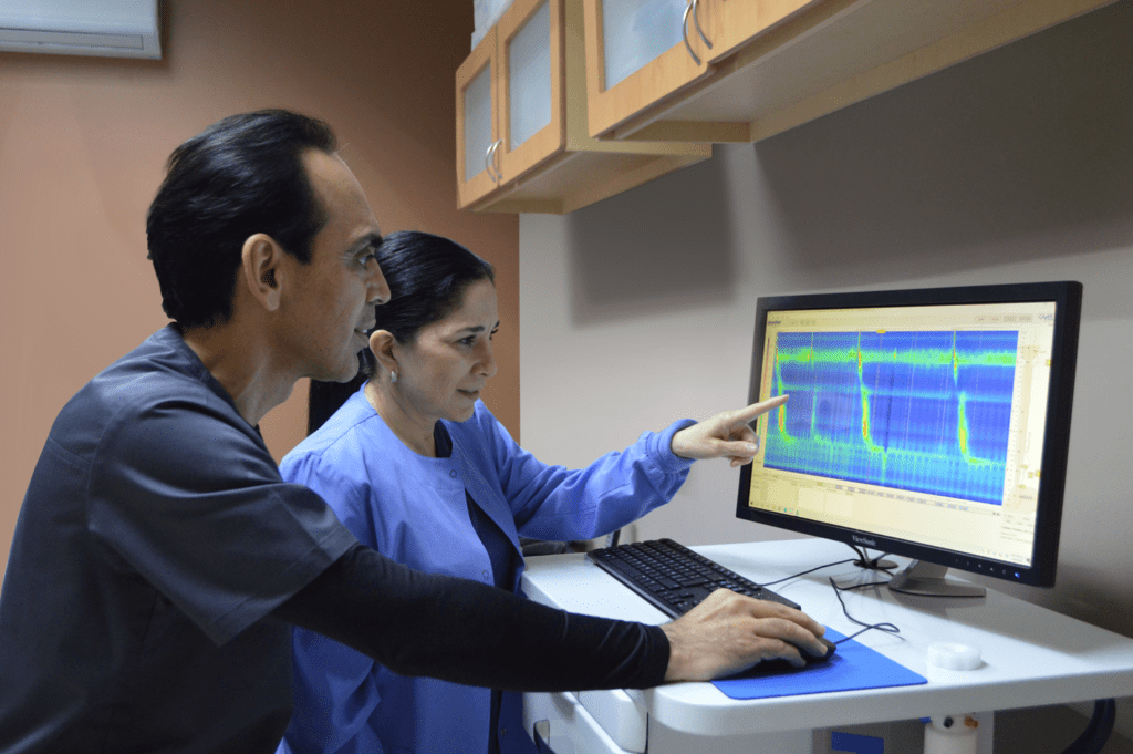 Doctors reviewing esophageal motility and digestive tract diagnostic test results on a computer screen for GERD evaluation and gastrointestinal disorder diagnosis at Jainamshree Multispeciality Hospital, Bhopal.